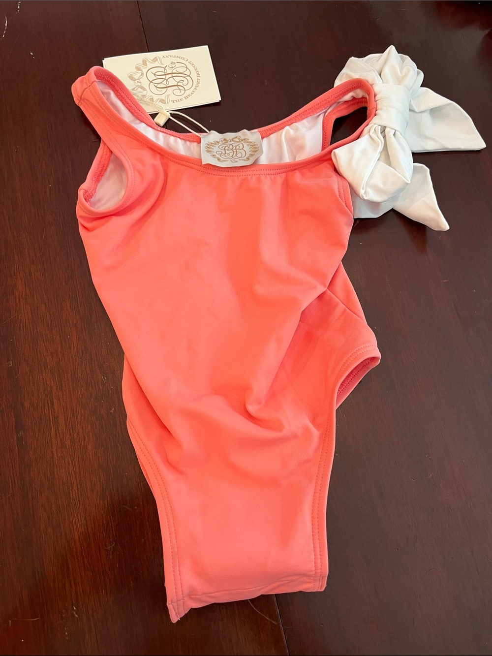 The Beaufort Bonnet Company Coral One-Piece Swimsuit with Cream Bow